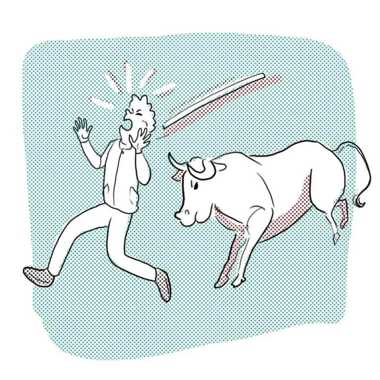 Un toro atacando a un hombre vestido de blanco que lo molesta con un palo